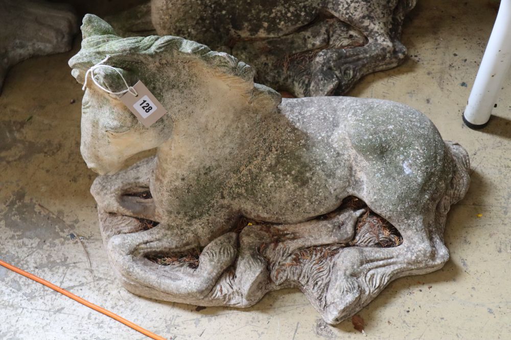 A pair of reconstituted stone recumbent horse garden ornaments, length 62cm